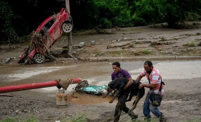 People flee from the landslide in Las Tejerias, Venezuela, Oct. 8, 2022.