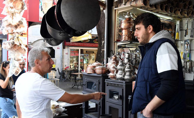 A man asks prices of stoves at a market in Istanbul, Türkiye, Oct. 11, 2022.