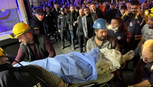 Paramedics and mine workers carry a wounded mine worker to an ambulance at the explosion site after an explosion occurred at a coal mine in Bartin, Turkey, 14 October 2022.