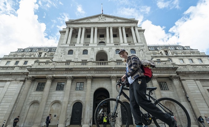 A woman walks past the Bank of England, London, U.K., 2022.