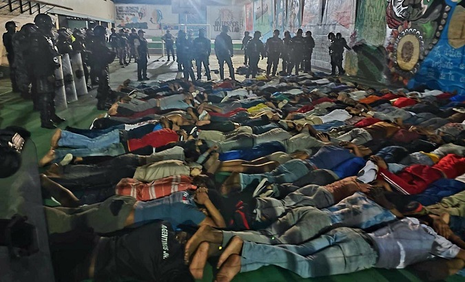 Inmates lie on the floor as police conduct searches at the El Inca prison, Quito, Ecuador, Nov. 7, 2022.