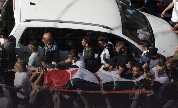 Palestinians carry the corpse of Sanaa at-Tal, Nov. 14, 2022.