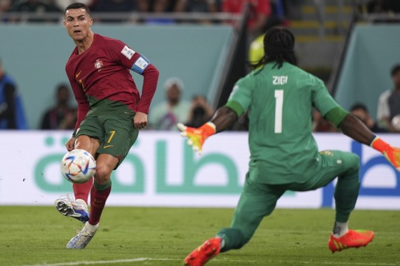 Cristiano Ronaldo (L) of Portugal shoots during the Group H match against Ghana at the 2022 FIFA World Cup at Ras Abu Aboud (974) Stadium in Doha, Qatar, Nov. 24, 2022.