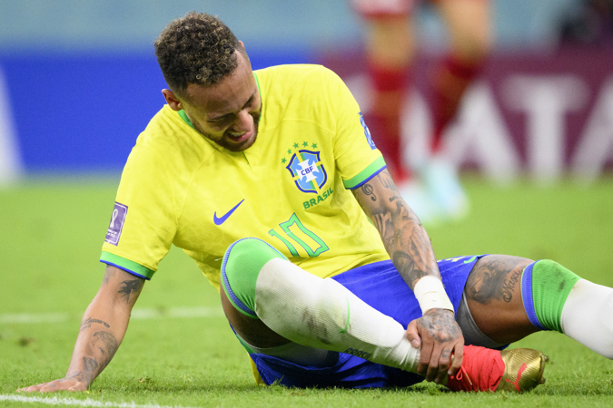 Brazil's forward Neymar holds his right ankle during FIFA World Cup 2022 group G soccer match between Brazil and Serbia at Lusail Stadium in Lusail, Qatar, 24 November 2022.