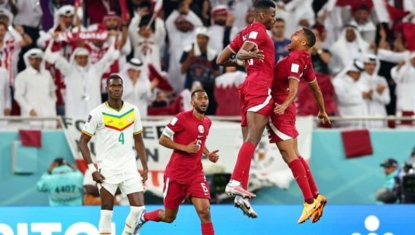 Mohammed Muntari (2nd R) of Qatar celebrates with teammate Pedro Miguel after scoring during the Group A match between Qatar and Senegal at the 2022 FIFA World Cup at Al Thumama Stadium in Doha, Qatar, Nov. 25, 2022.