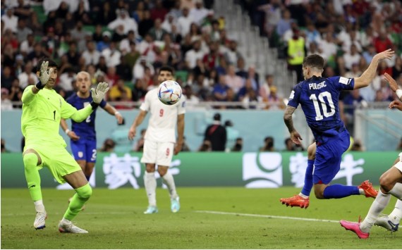 Christian Pulisic (R) of the United States shoots to score during the Group B match against Iran at the 2022 FIFA World Cup at Al Thumama Stadium in Doha, Qatar on Nov. 29, 2022.
