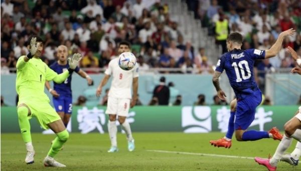 Christian Pulisic (R) of the United States shoots to score during the Group B match against Iran at the 2022 FIFA World Cup at Al Thumama Stadium in Doha, Qatar on Nov. 29, 2022. 