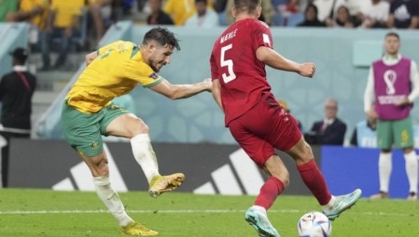 Mathew Leckie (L) of Australia shoots and scores during the Group D match against Denmark at the 2022 FIFA World Cup at Al Janoub Stadium in Al Wakrah, Qatar on Nov. 30, 2022.