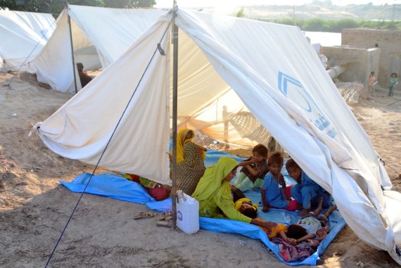 A flood-affected family is seen at a makeshift tent on the outskirts of Hyderabad, Pakistan, on Oct. 3, 2022.