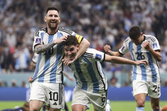Julian Alvarez (C) of Argentina celebrates scoring team's second goal with Lionel Messi during the semifinal against Croatia at the 2022 FIFA World Cup at Lusail Stadium in Lusail, Qatar, Dec. 13, 2022.