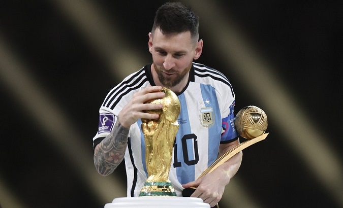 Lionel Messi looks at the World Cup Trophy at Lusail Stadium in Lusail, Qatar, Dec. 18, 2022.