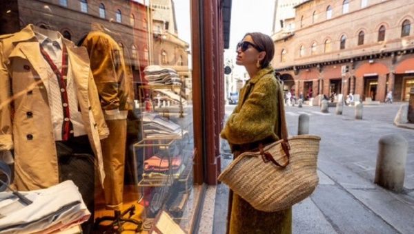 A woman looks at the products displayed in a store in Italy, 2022.​​​​​​​