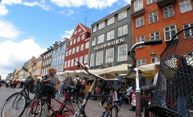 People walk down a street in Copenhagen, Denmark.