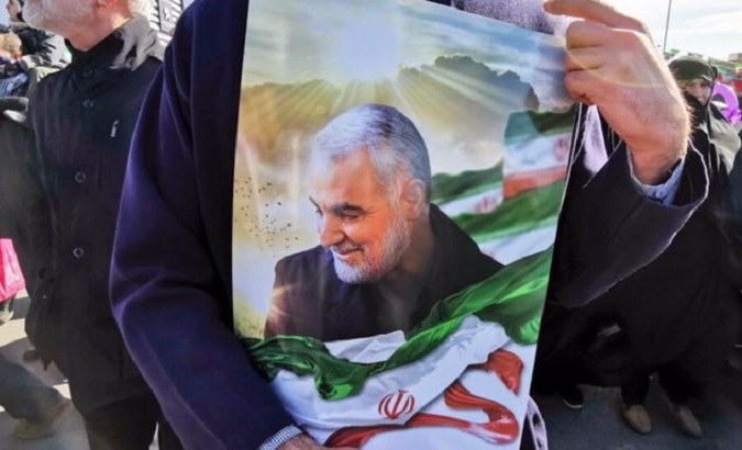 Iranian citizen holds photo of the late Commander Qassem Soleimani, Jan. 3, 2023.