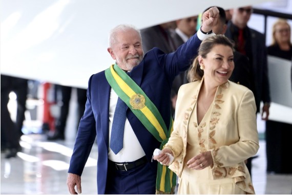 Luiz Inacio Lula da Silva (L), who is wearing the presidential sash, greets his supporters in Brasilia, Brazil, Jan. 1, 2023.