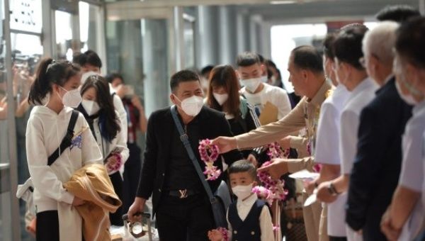 Chinese passengers are welcomed by Thai officials at the Suvarnabhumi Airport in Samut Prakan, Thailand, Jan. 9, 2022.