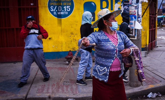 Woman throwing stones towards the Police, Juliaca, Peru, Jan. 10, 2023.