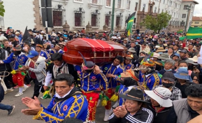 Peruvians accompany the coffin of Indigenous leader Remo Candia killed by security forces during protests, Jan. 12, 2023.
