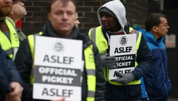 Rail workers stand at a picket line while on strike, London, U.K.