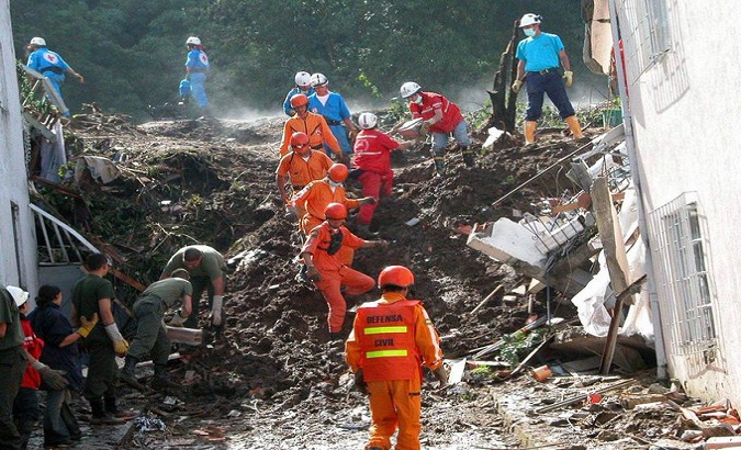 Rescuers help people affected by landslides, Colombia, December 2022.