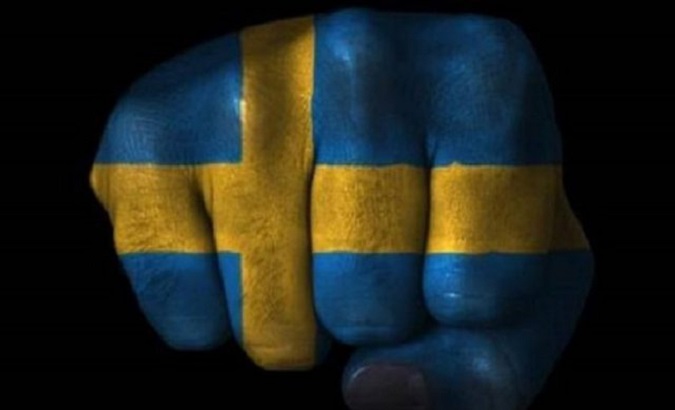 The Swedish flag painted on a hand