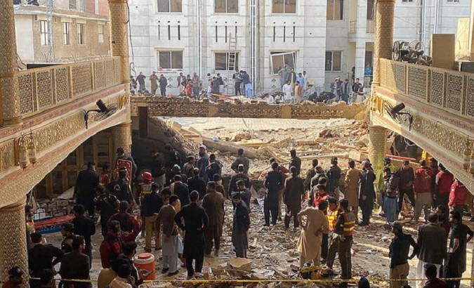 Police inspect the rubble at the mosque in Peshawar, Pakistan, Jan. 30. 2023.
