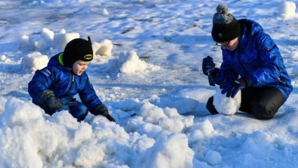 Children enjoy snow sculpture creation in Moscow, Russia, on Jan. 2, 2023.