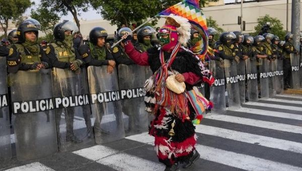 Indigenous dancer challenges the Peruvian police, 2023.
