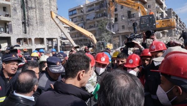 A handout photo made available by Syrian Presidential Office shows Syrian President Bashar al-Assad (C) visiting the site struck by earthquake in Aleppo, Syria, 10 February 2023.