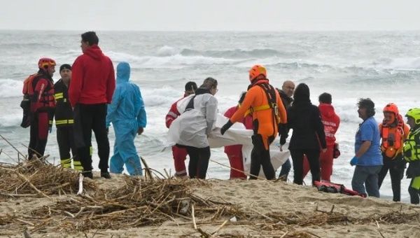 Rescue brigades collect bodies of shipwrecked people on the shores of Steccato di Cutro, Italy, Feb. 26, 2023.