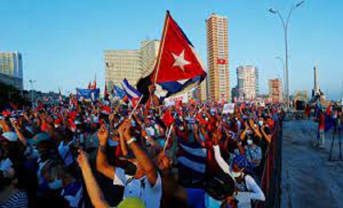 Citizens hold the national flag in a rally, Havana, Cuba.