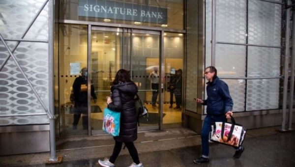People walk past a Signature Bank branch in New York, the United States, on March 13, 2023.