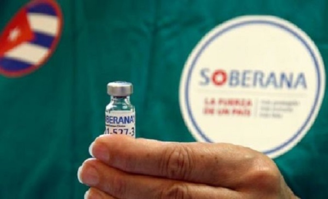 A health worker shows a sample of the Sovereign 02 vaccine, Cuba.
