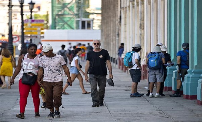 People walk down a street in Havana, Cuba, Feb, 25, 2023.