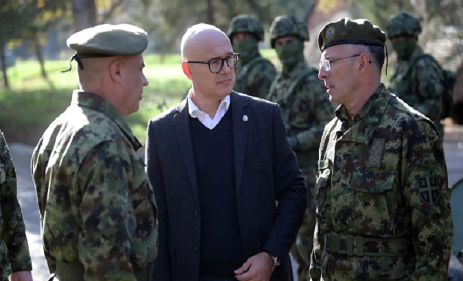 Serbian Defense Minister Milos Vucevic (C) with two militaries.