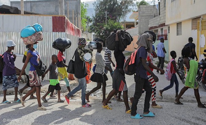 Haitian people flee gang-related violence, 2023.