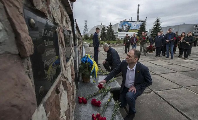 Nuclear power plant workers laying flowers at a monument to the victims of the Chernobyl accident. Apr. 27, 2023.