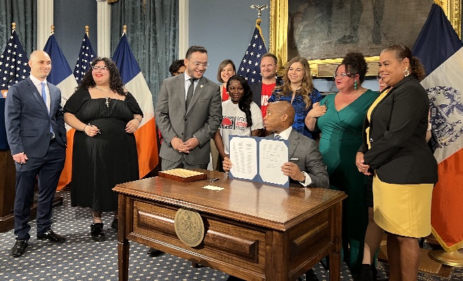 NYC Mayor Eric Adams signing the law, May 26, 2023.