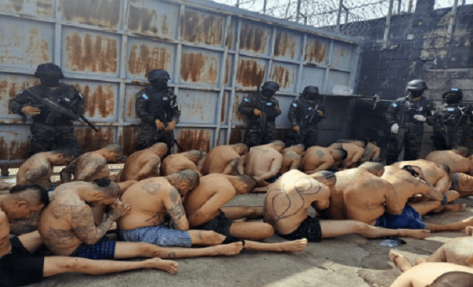 Military police guard prisoners in a Honduran jail, June, 2023.
