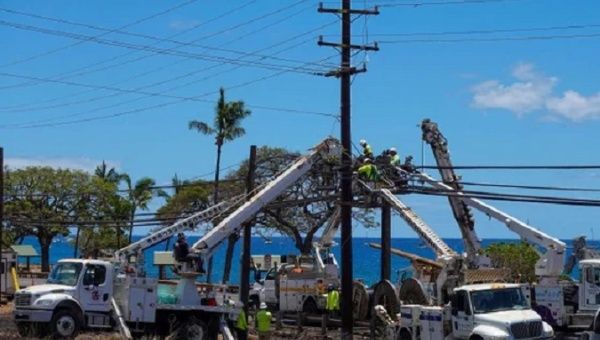 Workers begin to repair electrical infrastructure affected by wildfires in Hawaii, Aug. 2023.