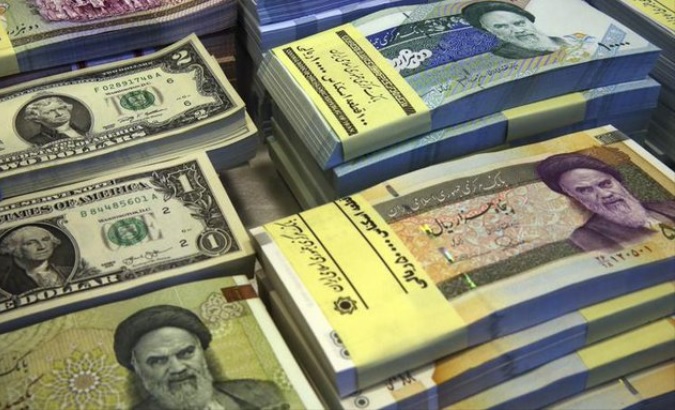 U.S. dollar and Iranian rial banknotes.
