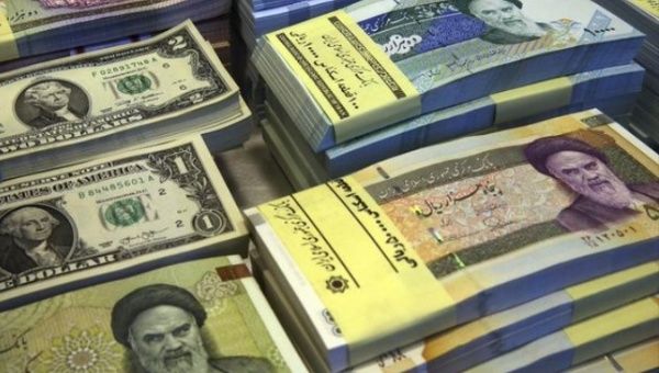 U.S. dollar and Iranian rial banknotes.