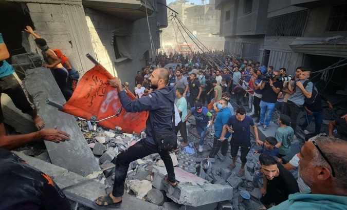 Rescuers try to save victims of the Israeli bombing in Gaza, Oct. 25, 2023.