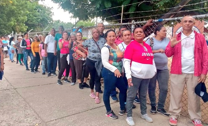 Venezuelans line up to participate in the electoral simulation related to the Essequibo referendum, Nov. 19, 2023.