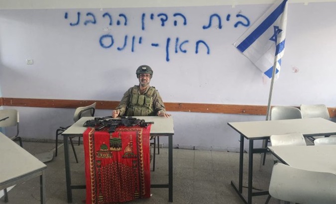 Israeli soldier poses after occupying a school in Gaza, Dec. 11, 2023.