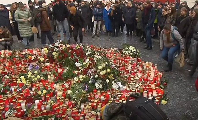 Flowers in memory of the victims at Charles University's Karolunim, Prague, Dec. 22, 2023.