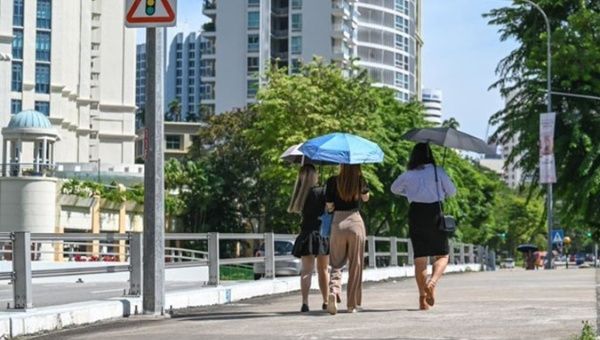People protect themselves from the intensity of sunlight in Singapore.