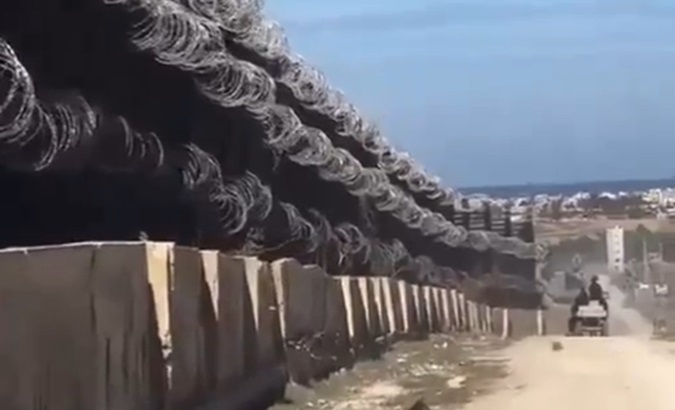 Concrete wall with barbed wire on the border between Egypt and Gaza, 2024.