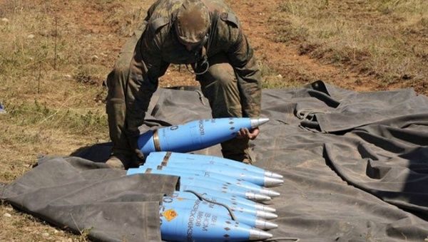 A soldier lifts European weapons.