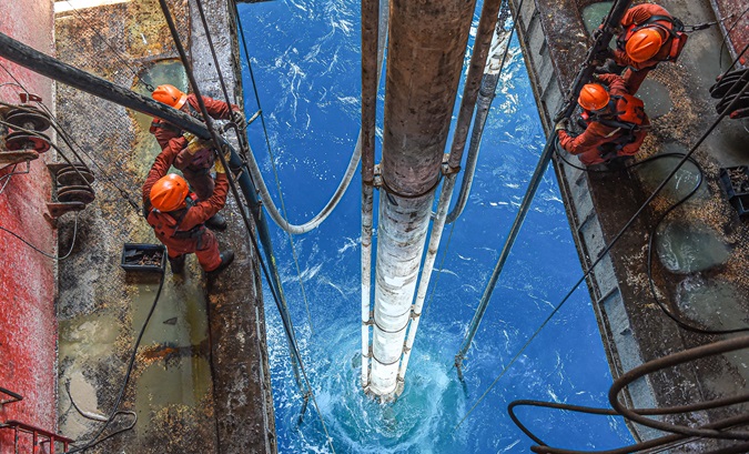 Workers at an offshore oil platform in South China, 2024.